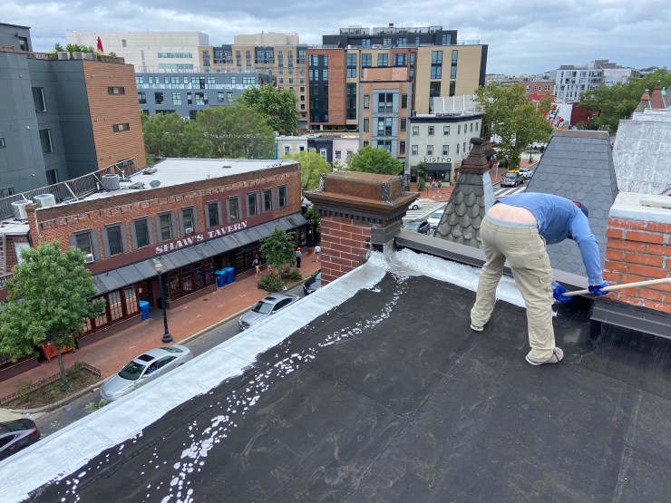 Rubber roof being coated
