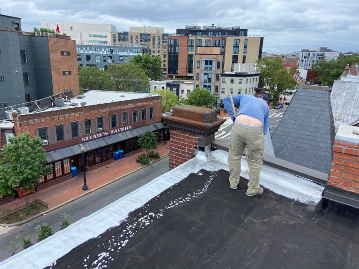 Rubber roof being coated